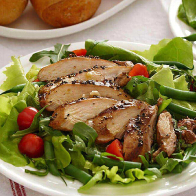 grilled chicken over leafy green salad